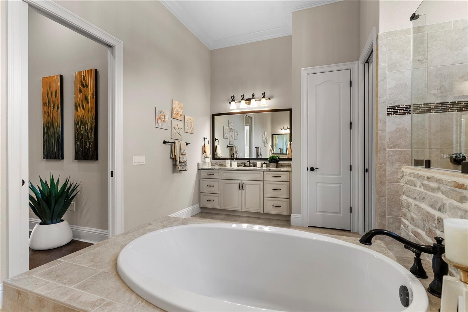 The primary spa-like bath also includes dual water closets and a massive walk-in shower with dual showerheads and two body sprays per person.