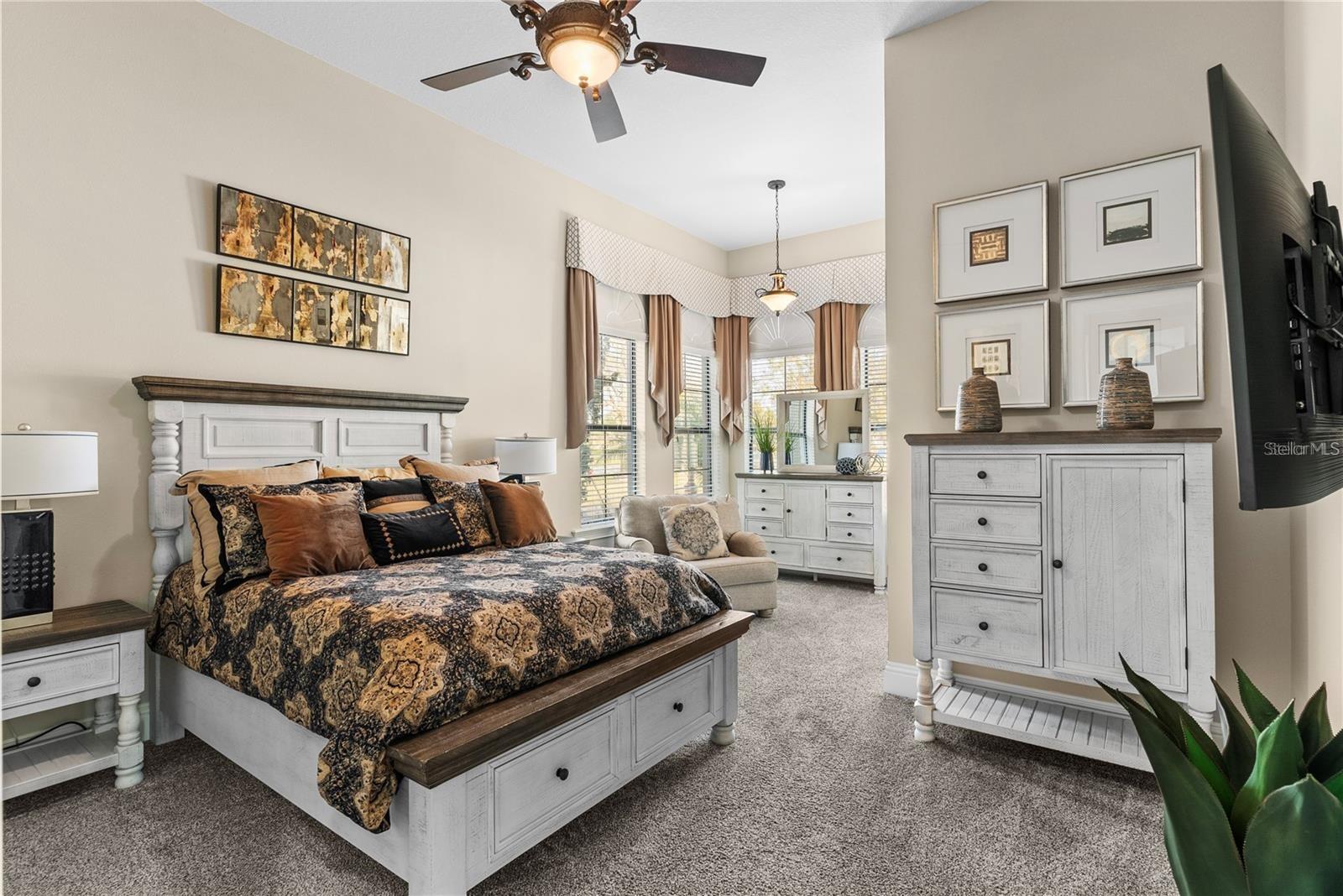 First-floor bedroom featuring a cozy sitting area, a spacious walk-in closet, and convenient access to a Jack-and-Jill bathroom. Perfectly situated near the elevator, mudroom, and garage for ultimate ease of living.