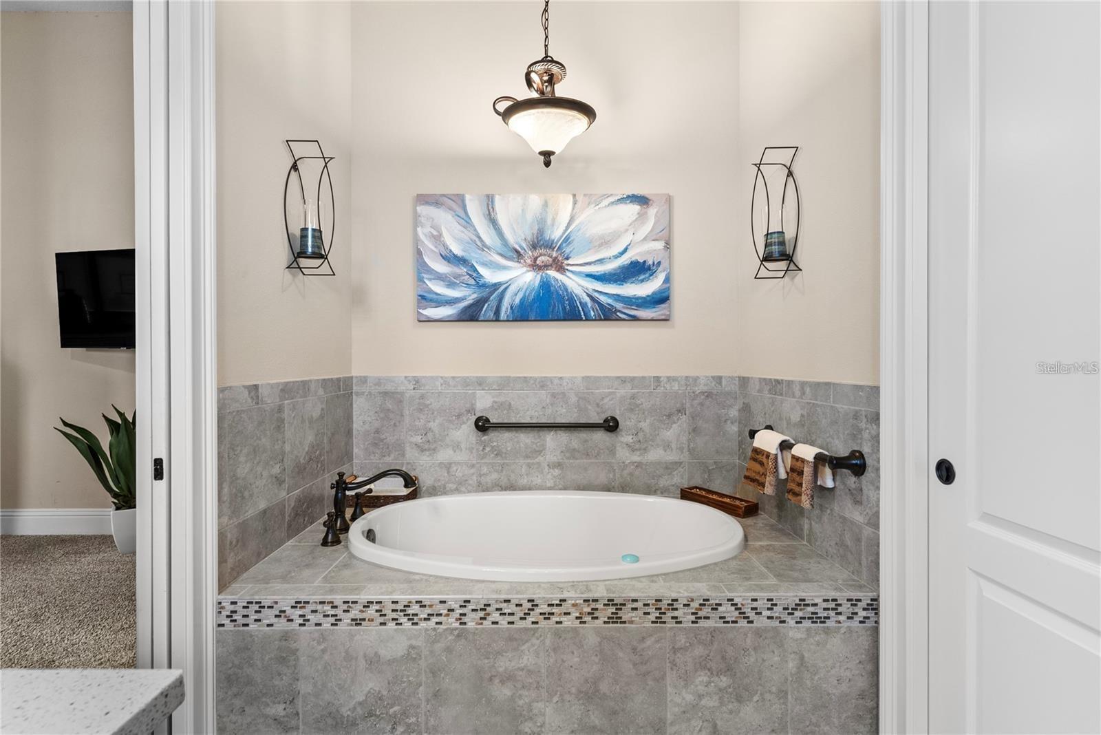 With its elegant drop-in garden tub, convenient pocket doors, and stylish design, this bathroom is the perfect combination of comfort and sophistication.