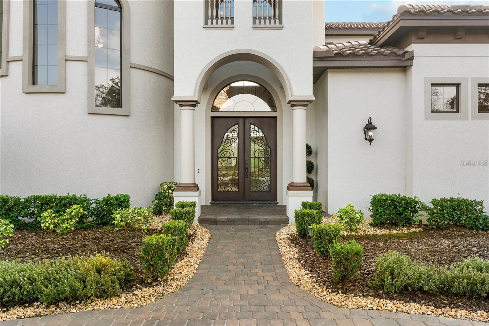 This Mediterranean estate in Stonelake Ranch is a masterpiece of luxury living, featuring a grand front elevation, stately double-door entry, and soaring two-story ceilings.