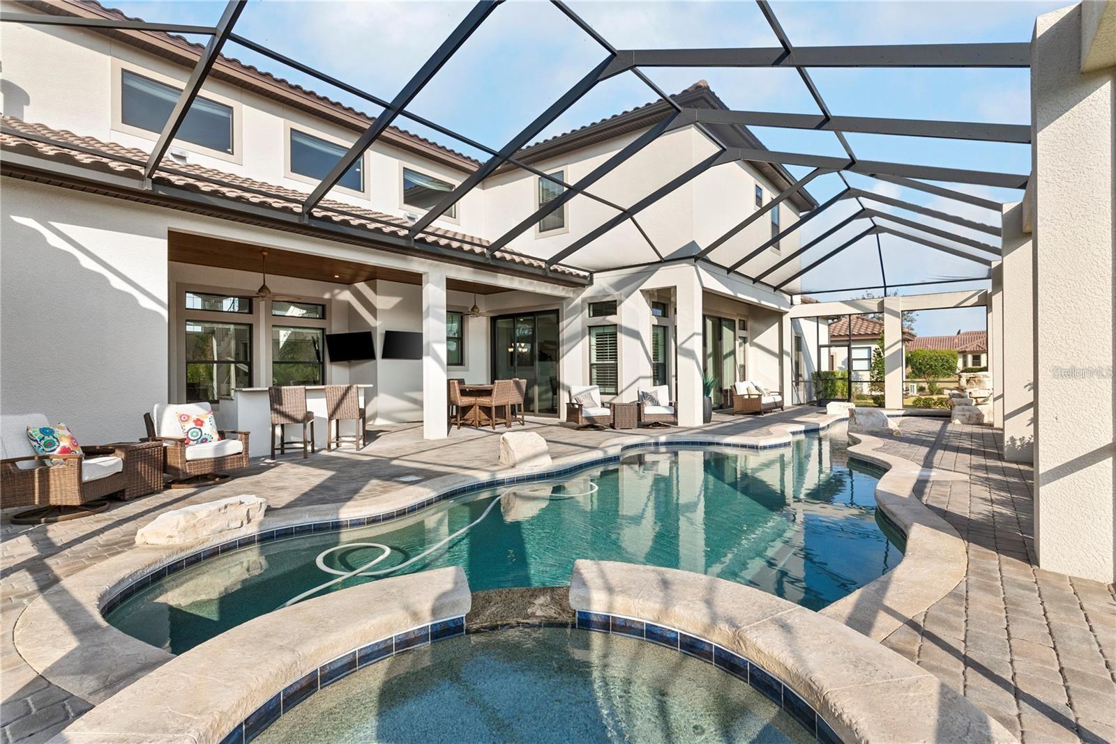 The backyard is an entertainer’s paradise, featuring a resort-style pool.