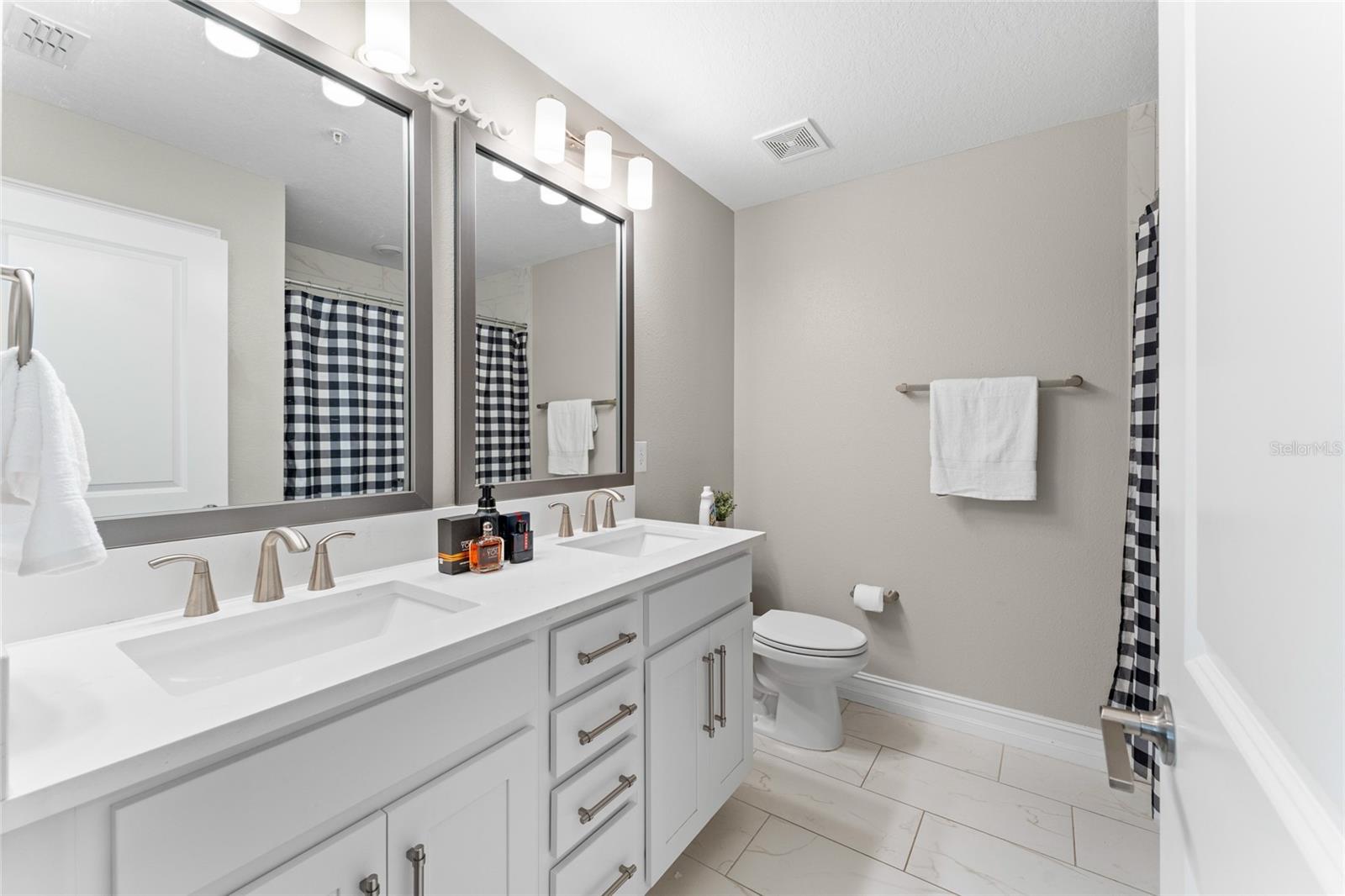 Private en-suite bathroom with double vanity.