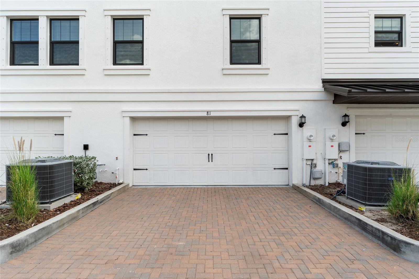 Back side of property- Driveway & Two Car Garage