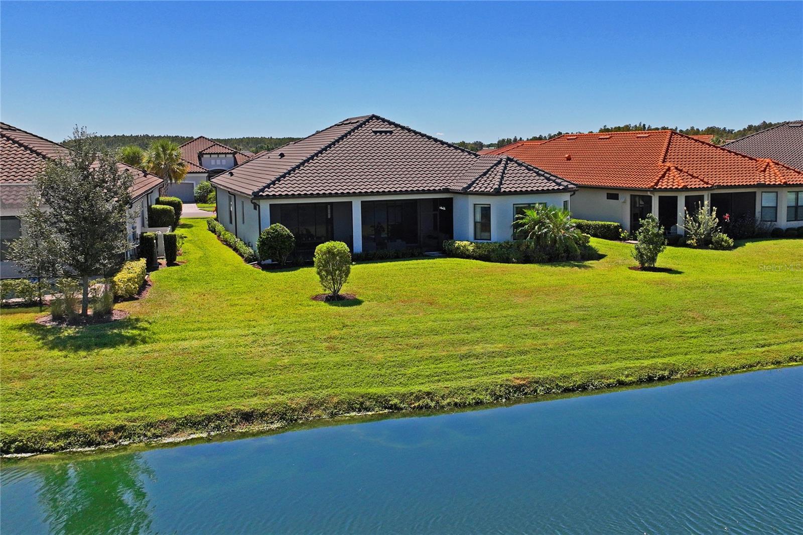 Drone view from retention pond to backyard