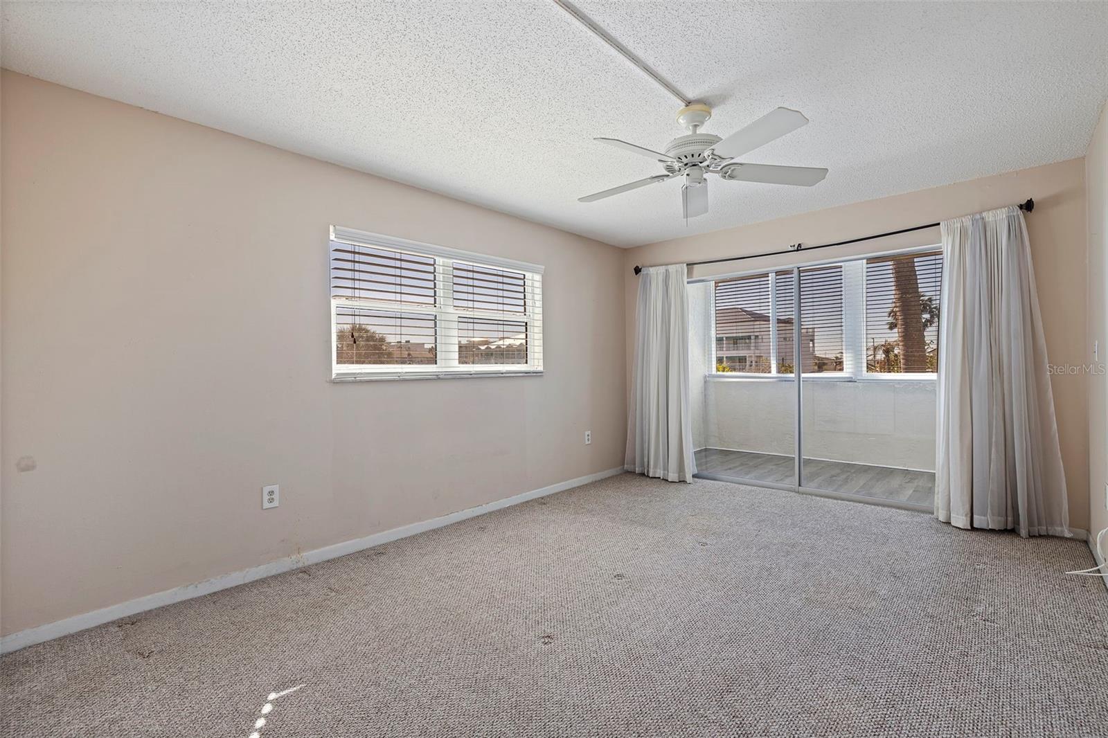 Primary bedroom with sliders to the bonus room.