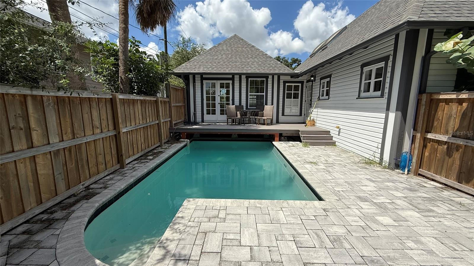 Fenced in Pool Area. new pavers.  pool currently occupies the driveway.