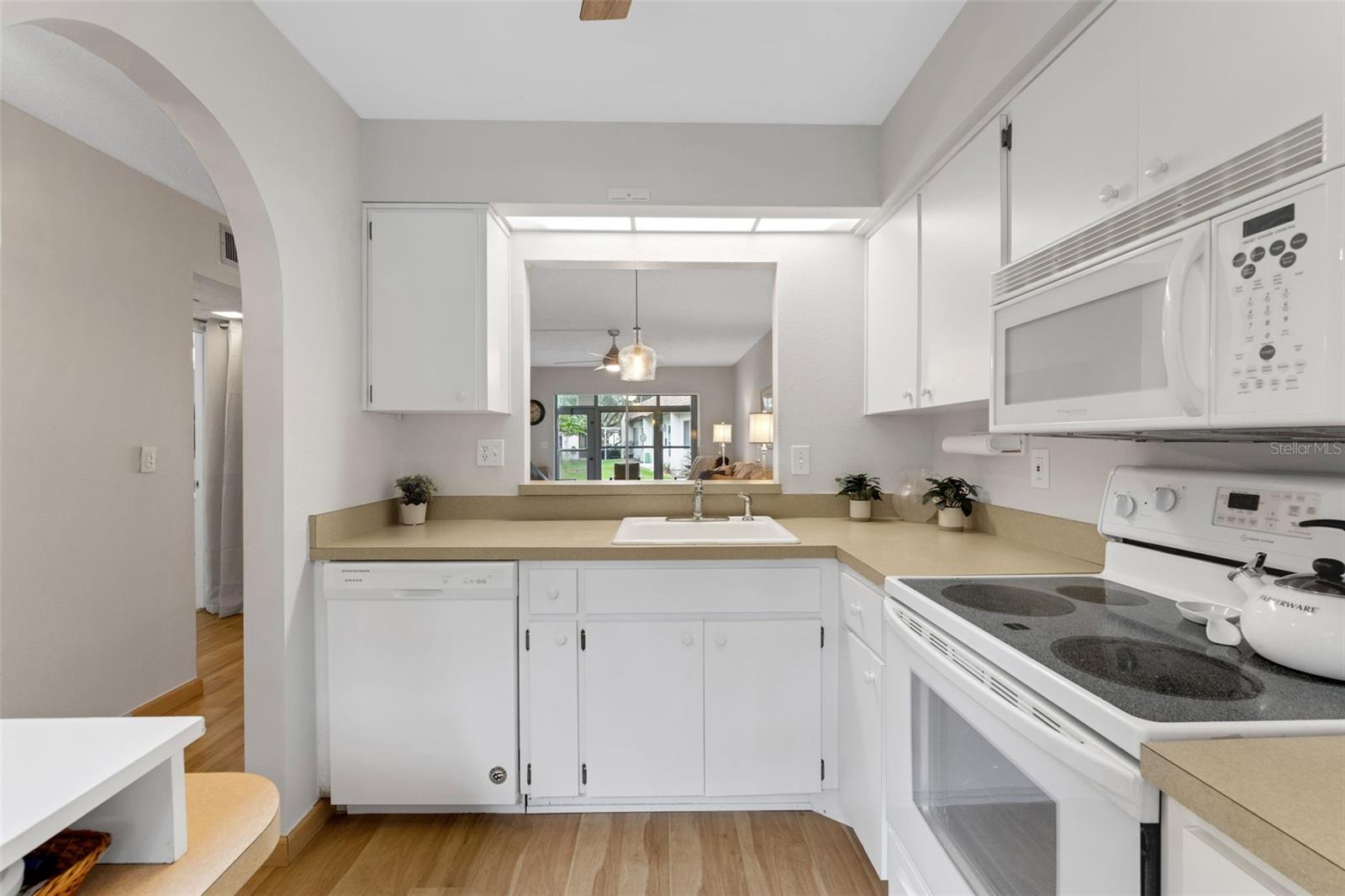 Architecturally pleasing Arch leads to kitchen