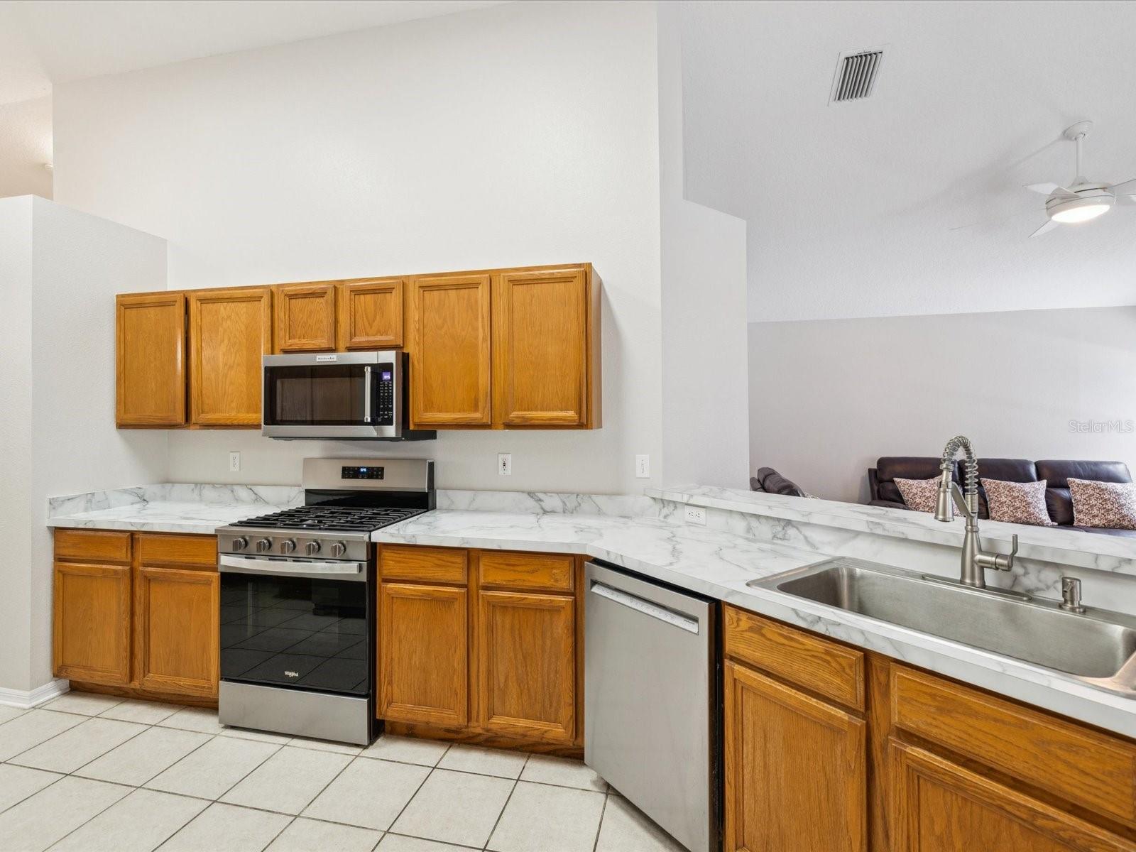 The kitchen includes newer stainless steel appliances.