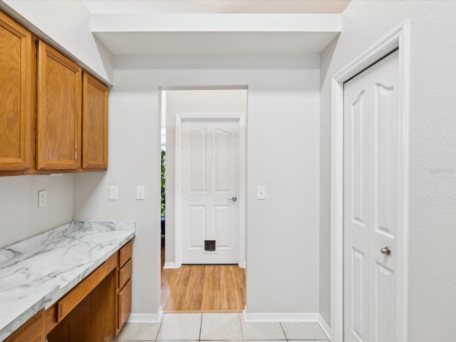 The work station on the left is perfect for a coffee and snack bar. The door leads to the laundry room and garage entry.