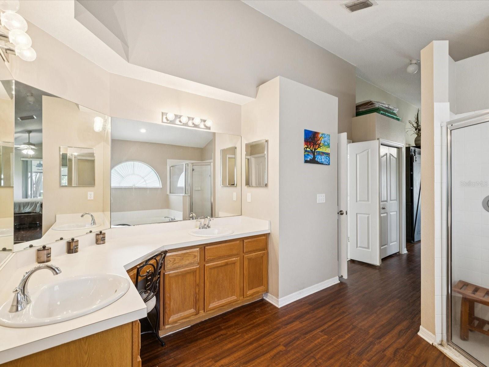Dual vanities and extra cabinetry provide plenty of space.