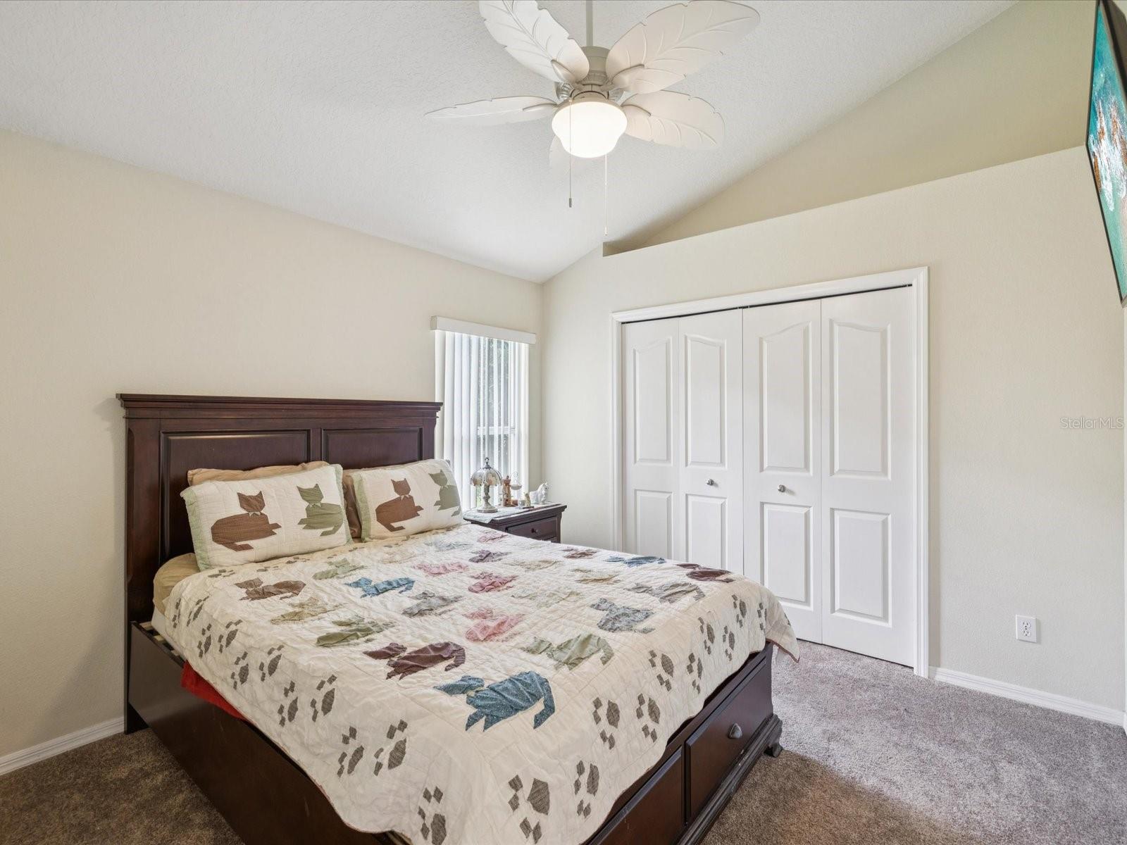The 4th bedroom features a vaulted ceiling, fan and brand new carpet.