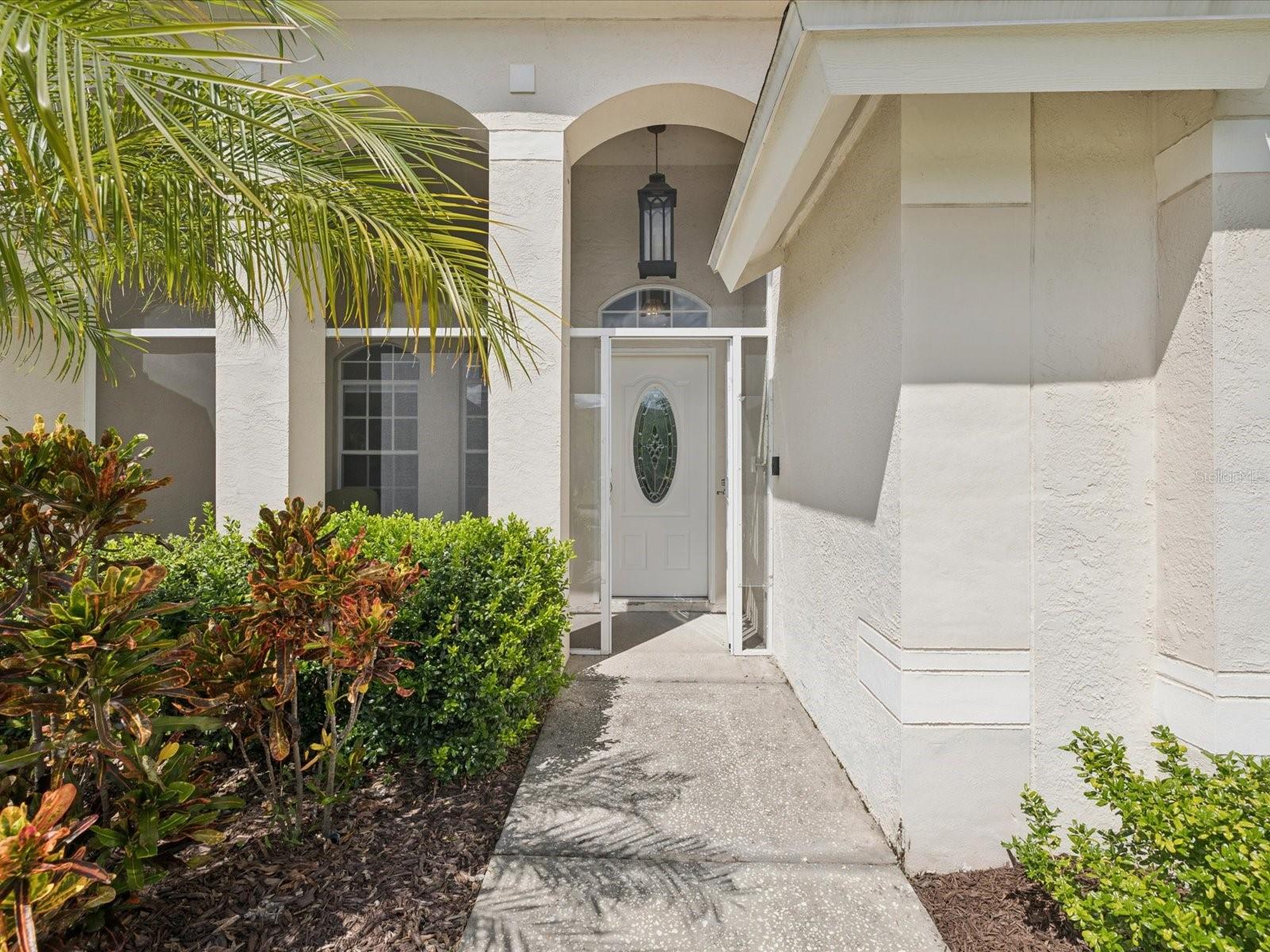 Mature landscaping leads you to the welcoming front porch.