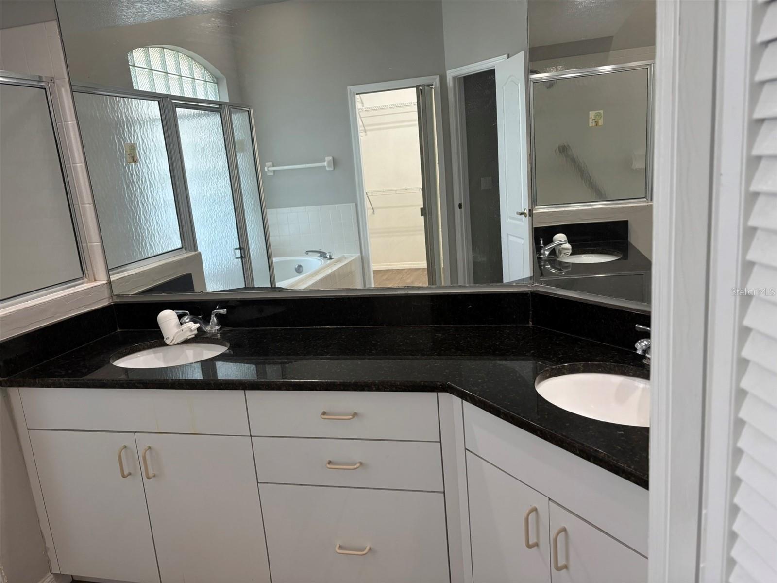 Primary Bathroom linen closet and double vanity