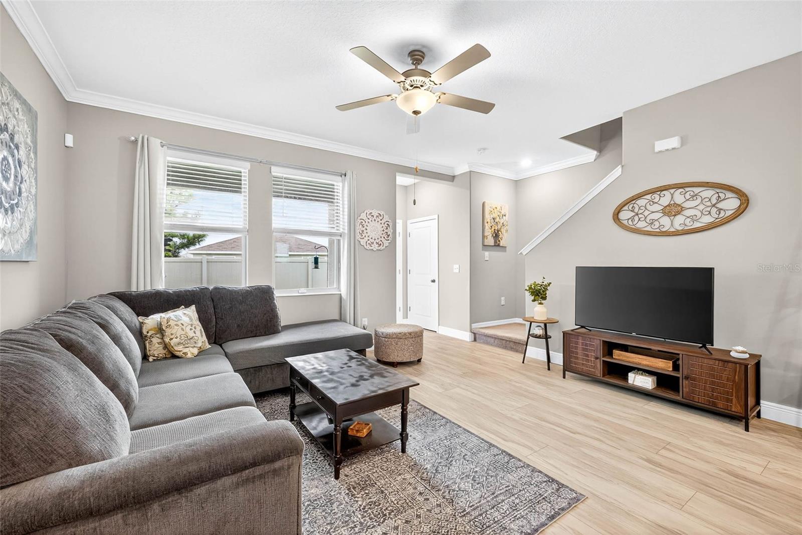 Large living area with overhead lighting and fan.