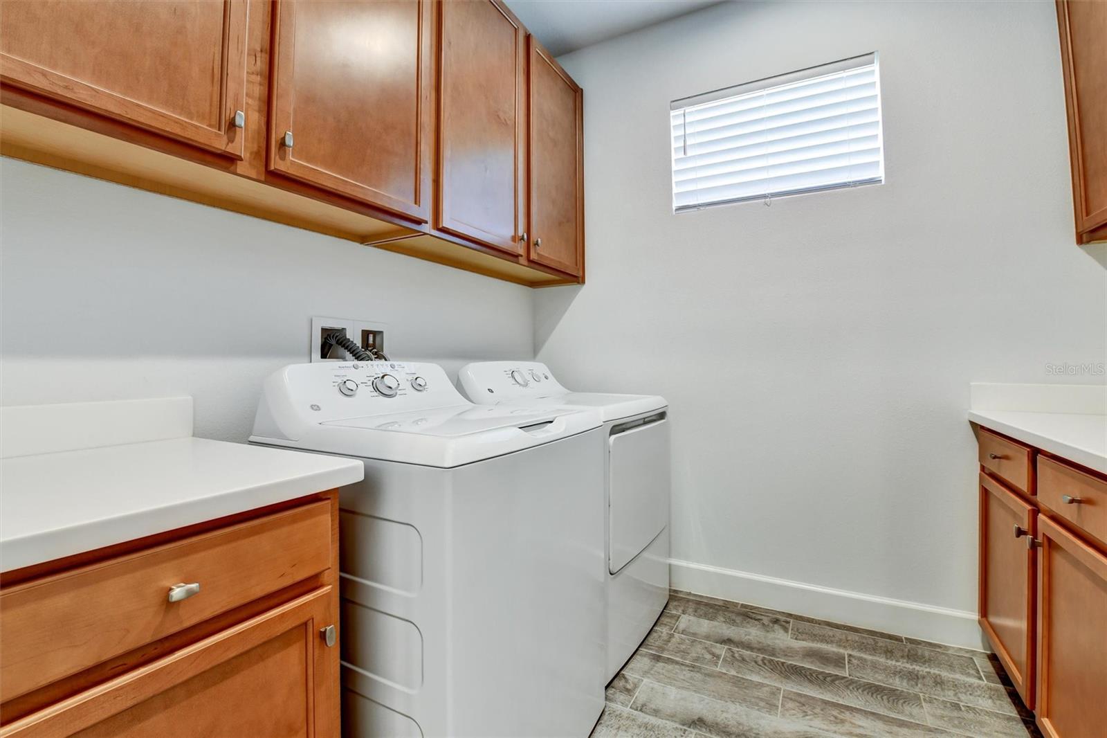 Laundry room with full cabinetry