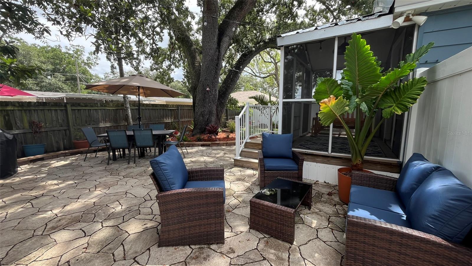 View of outdoor sitting area and screened porch