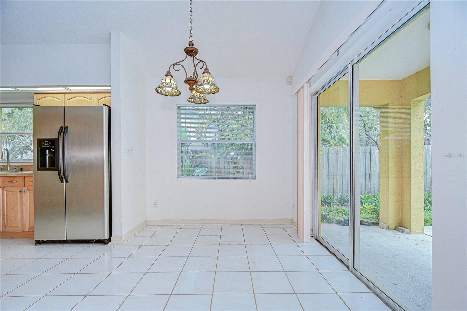 Dinette with slider sleading to backyard