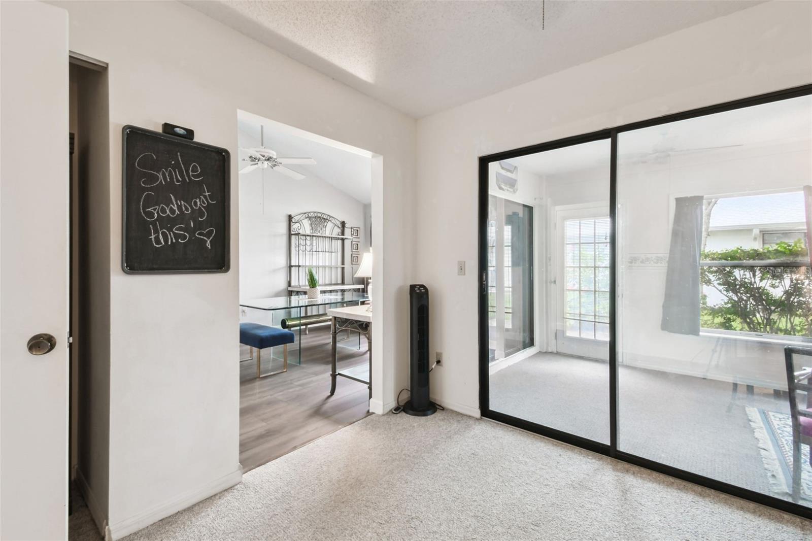 office or 3rd bedroom with closet and sliders to the florida room
