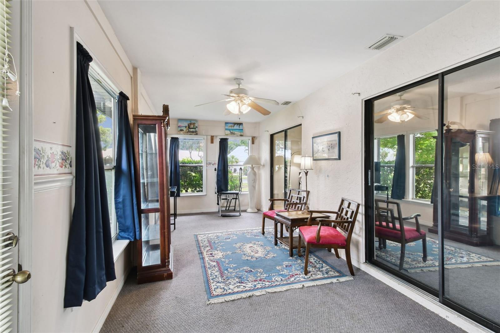 Florida room with access and sliders to the 3rd bedroom/ office/ lliving room and primary suite!