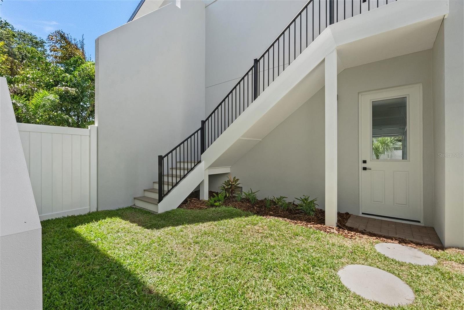Courtyard separating the main home from the 2-car garage with an accessory living unit located above the garage.