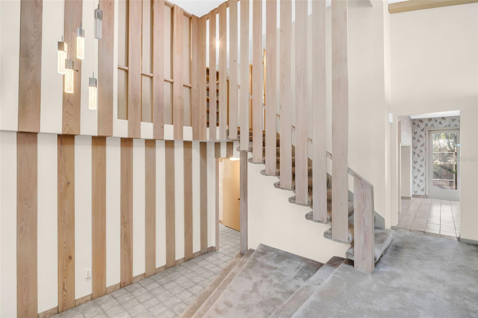 Foyer with stairs to living room and second floor