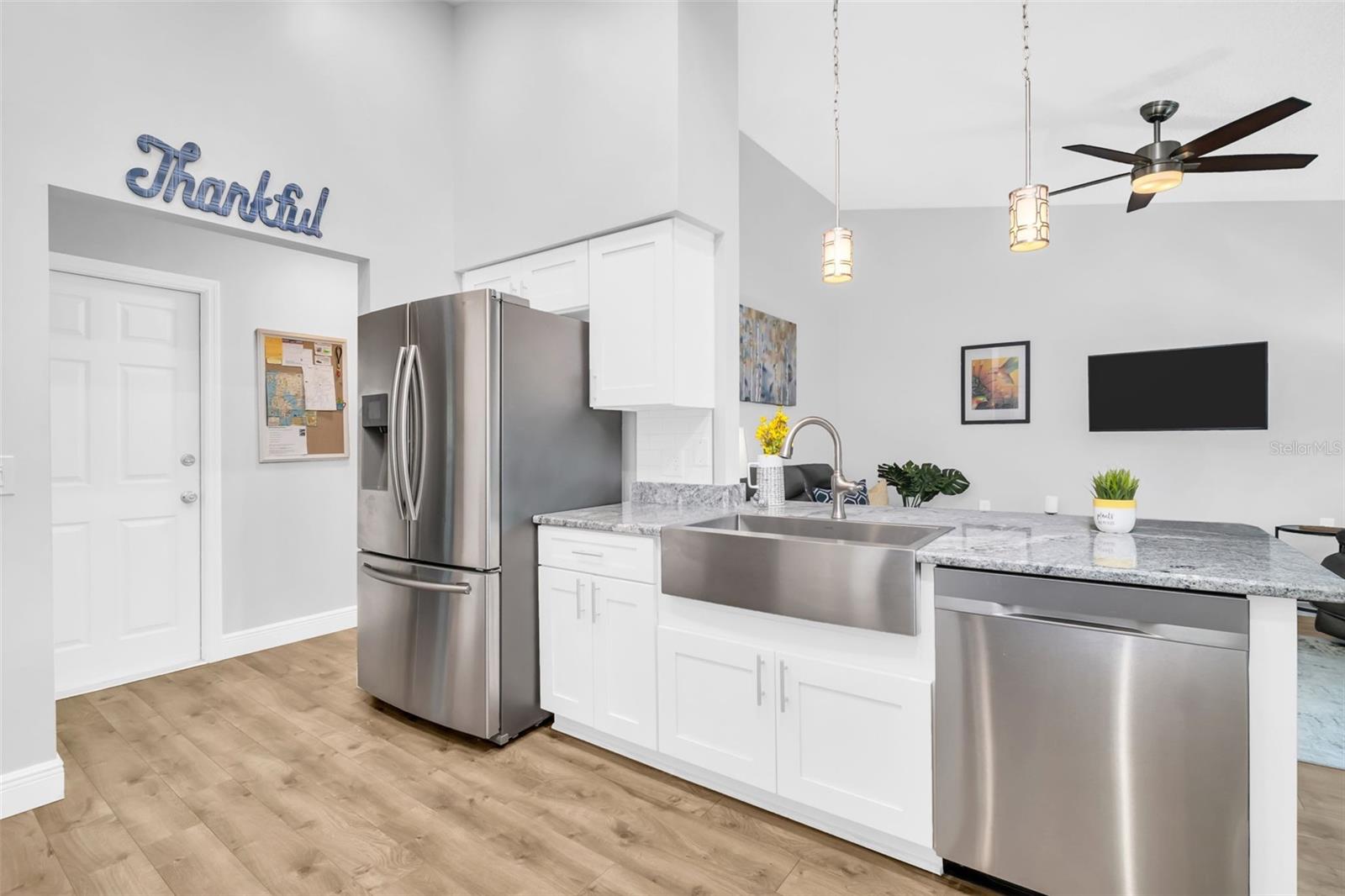 Open to family room and the wide hallway leads to the full 2-car garage and large indoor laundry room~