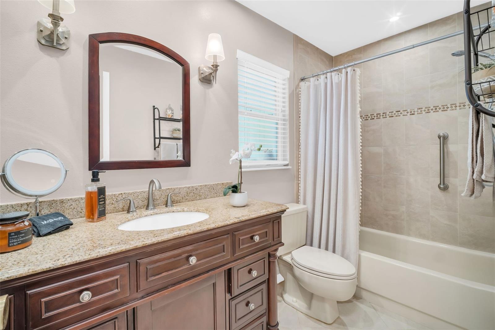 Beautifully updated hall bath with newer vanity, lighting, and tub/shower combo~
