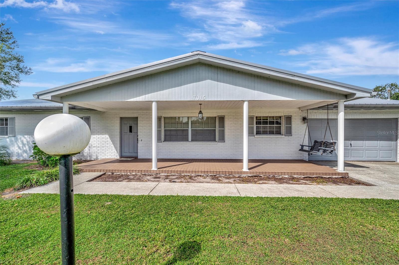 Front exterior with covered porch and swing