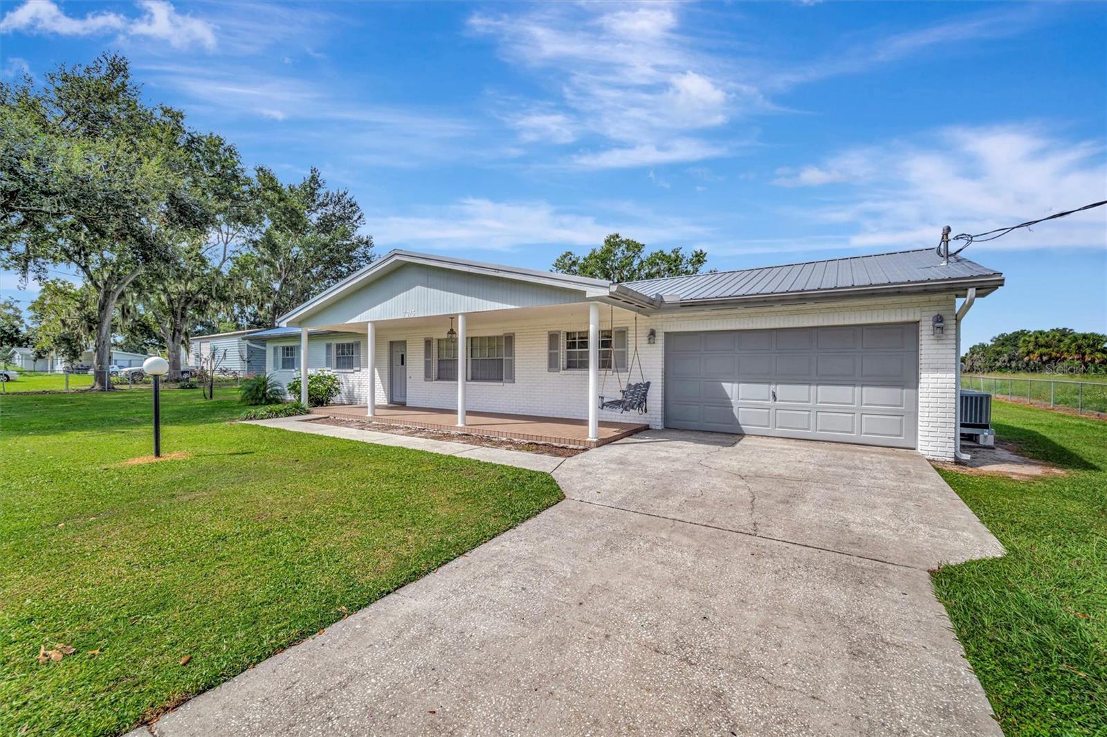 Angled front view with driveway and garage