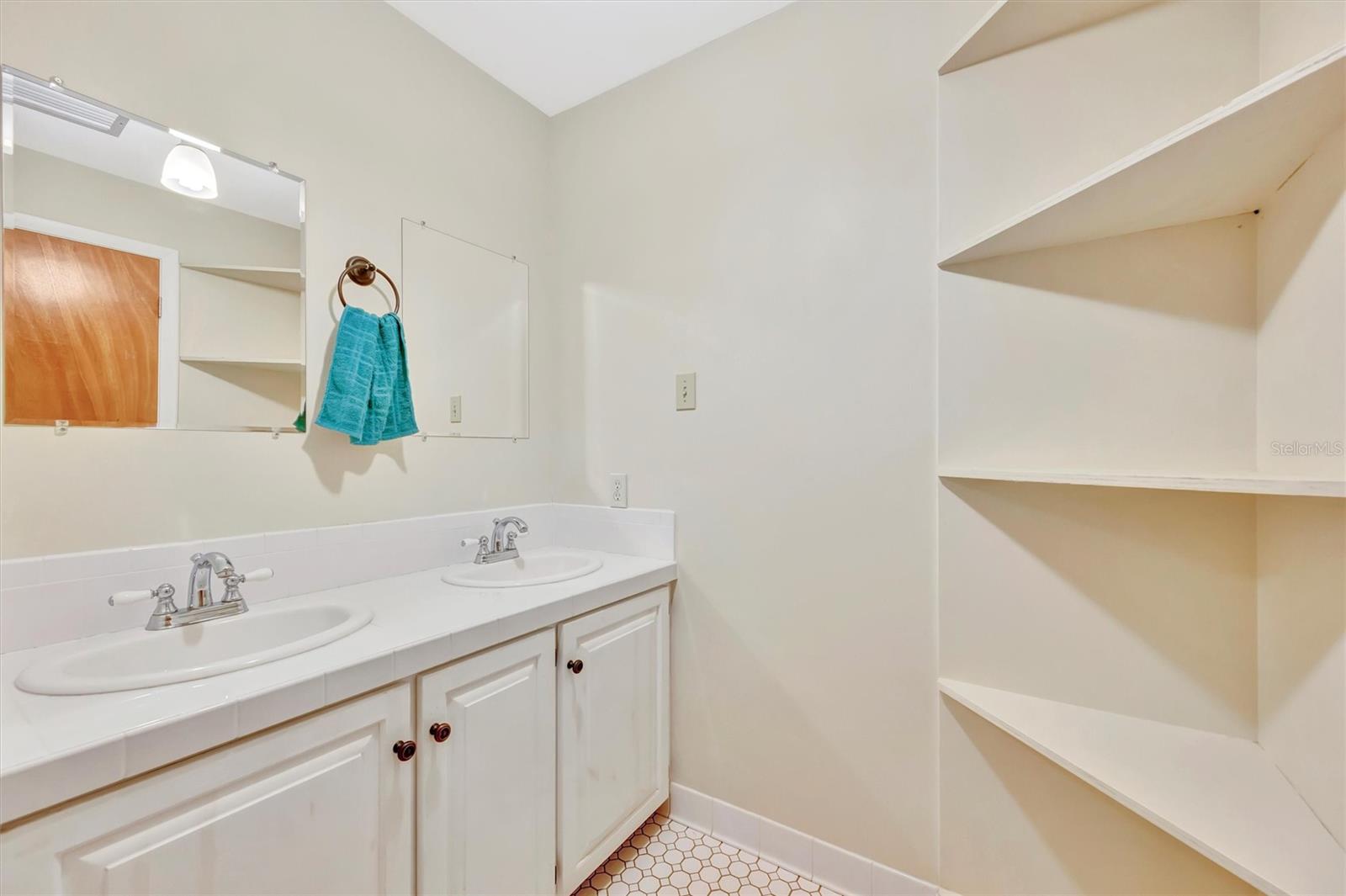 Double vanity offers added convenience and storage in this thoughtfully designed space.