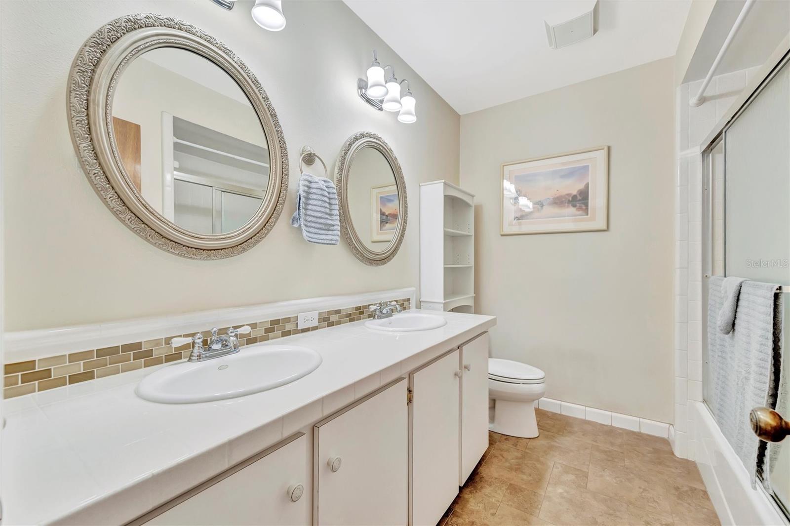 Bathroom 2 with convenient dual sinks and ample counter space.