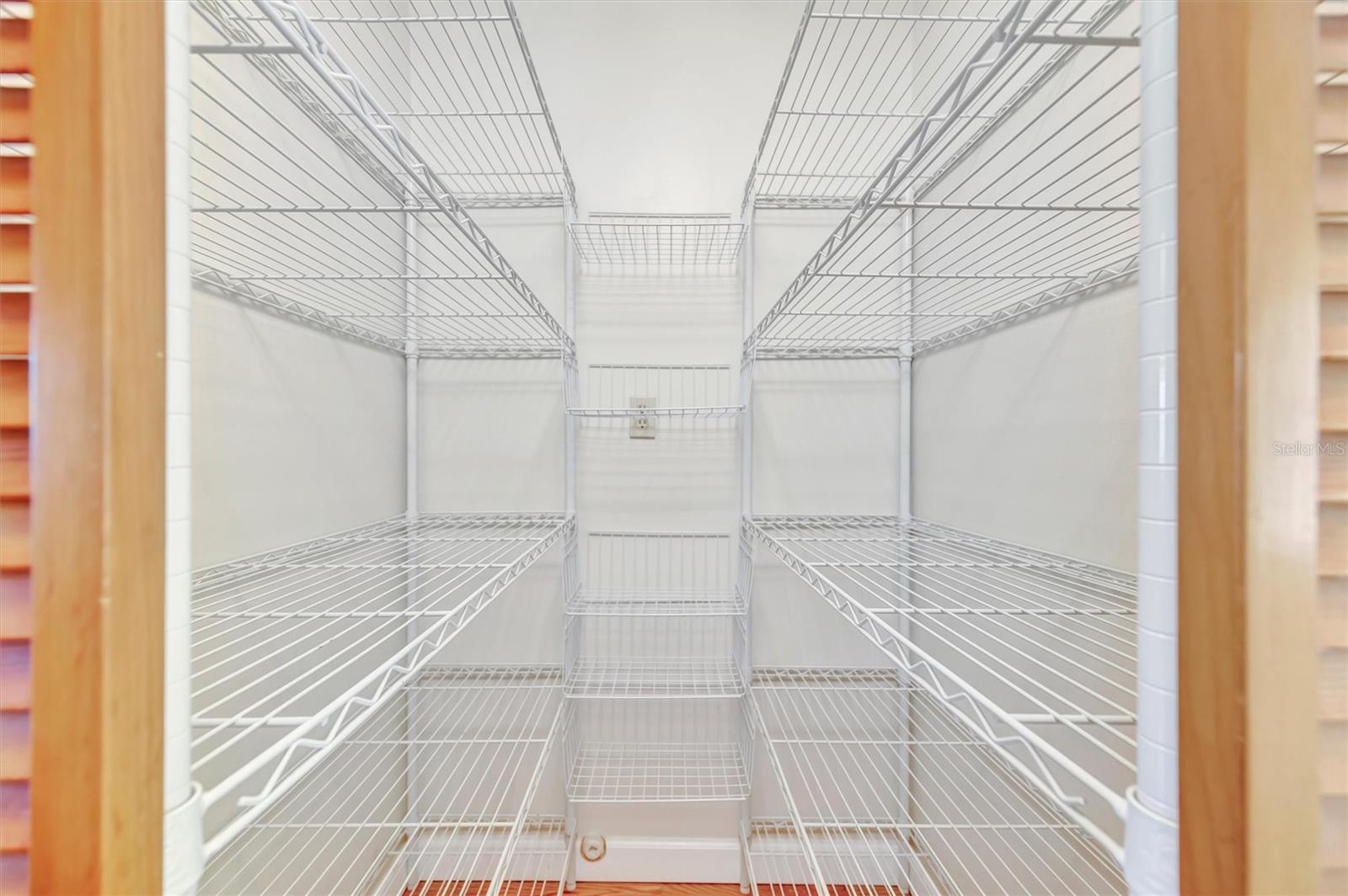 Large walk-in pantry offering ample storage and easy kitchen access.
