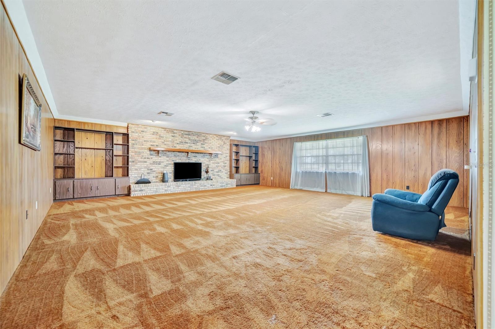 Family Room-Huge family room with abundant natural light and cozy fireplace.