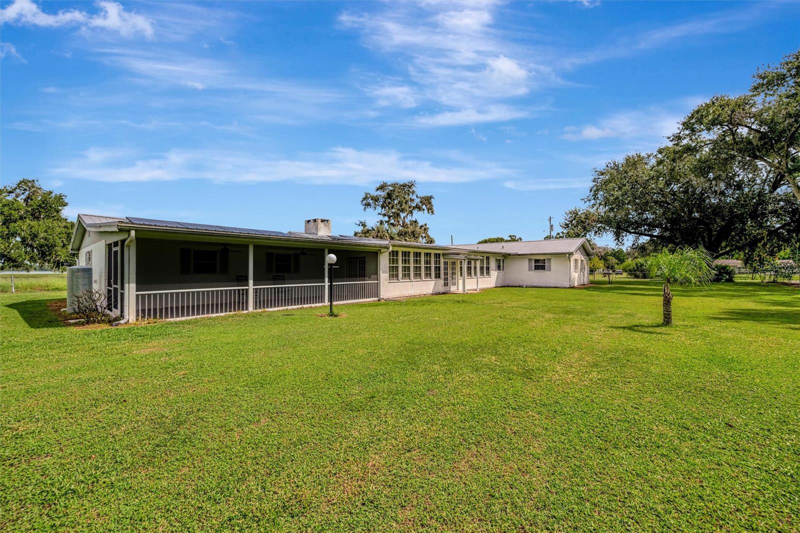Beautiful exterior view showcasing the spacious screened porch and bright sunroom