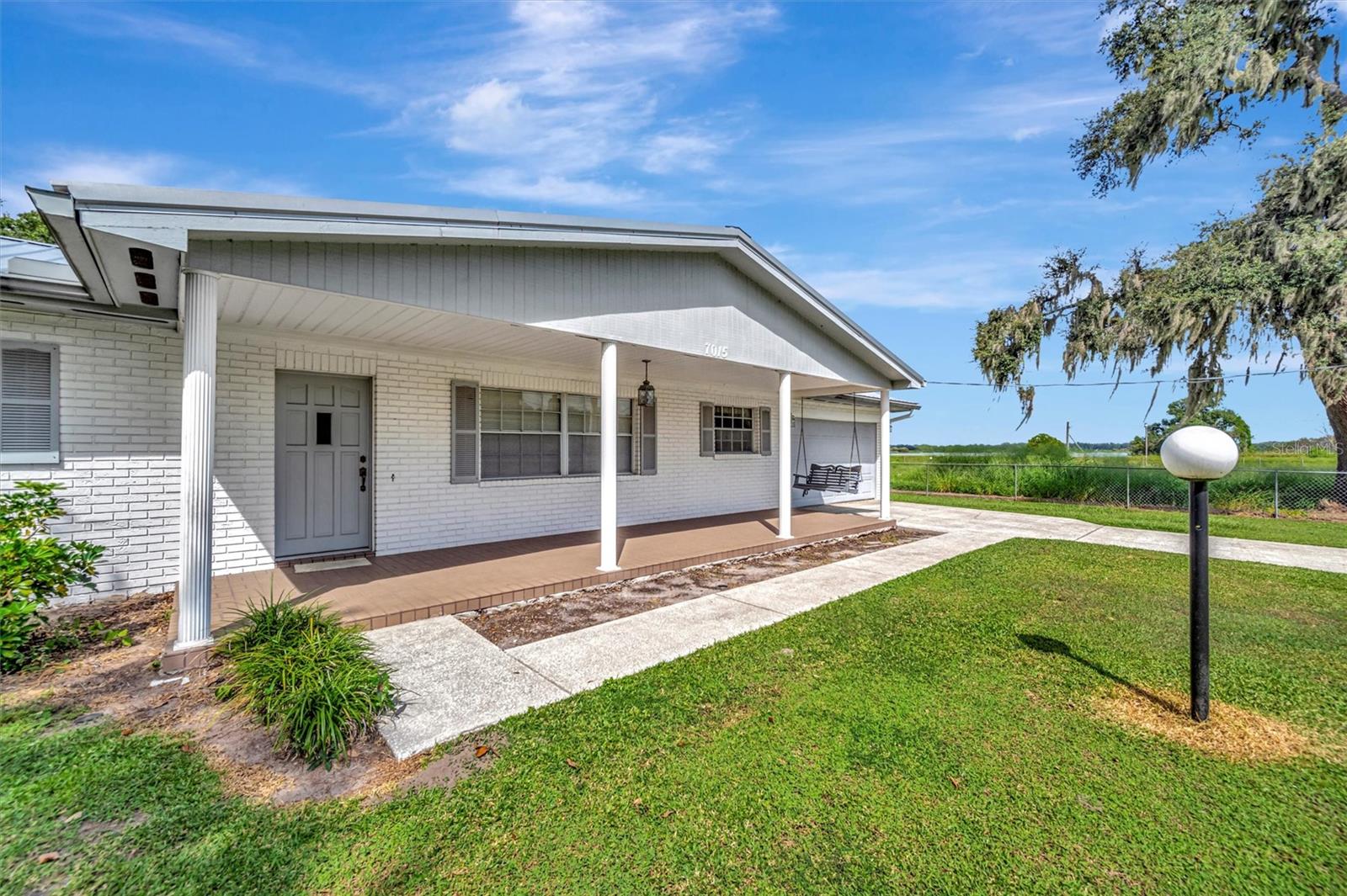 Charming front view of the home with a covered porch and inviting curb appeal.
