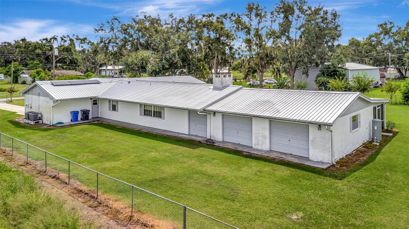 Spacious side garage with room for 3–4 cars, boats, or equipment
