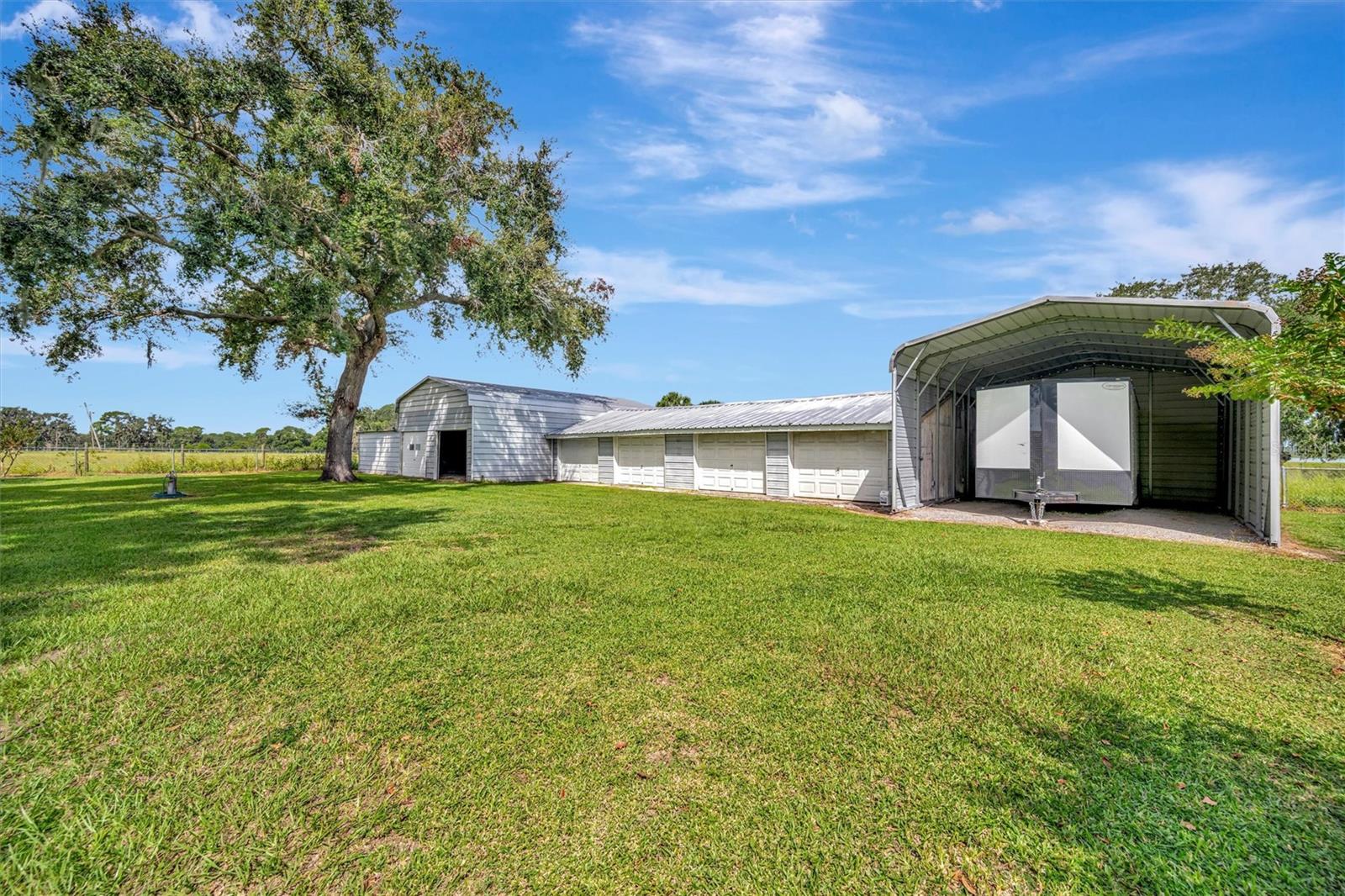 Covered RV carport with electric hookup—ready for your travel trailer or motorhome.