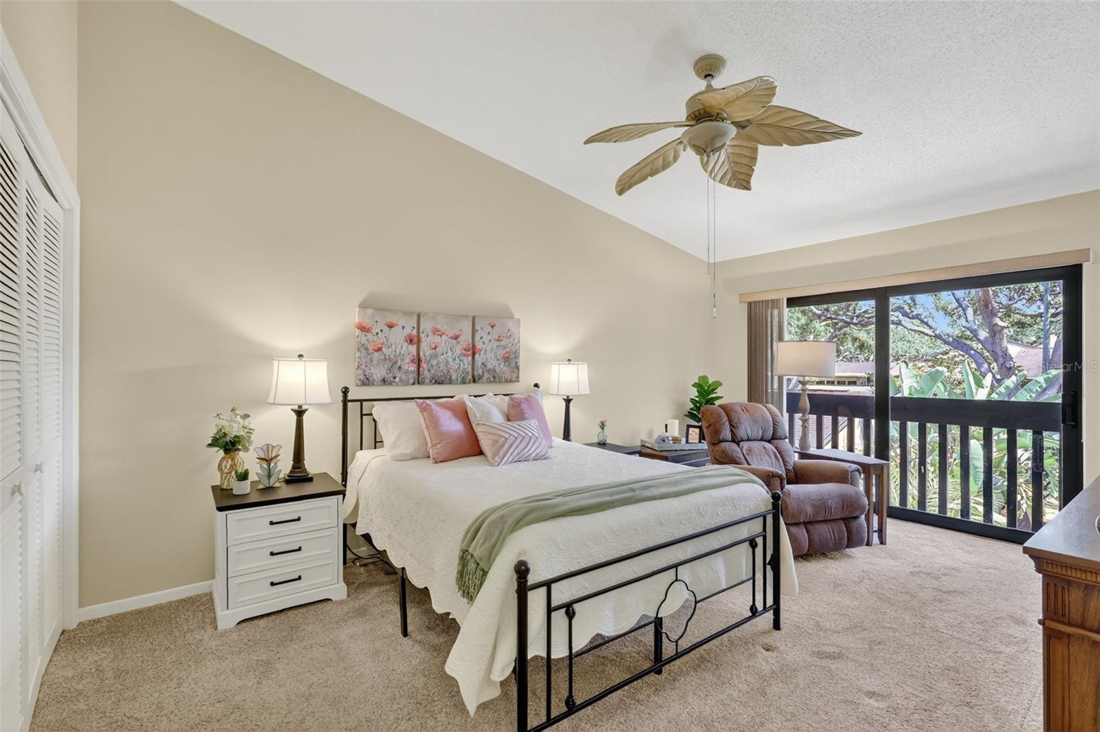 The Primary Bedroom is large and has plenty of closet space, along with a juiiet balcony overlooking the front courtyard.