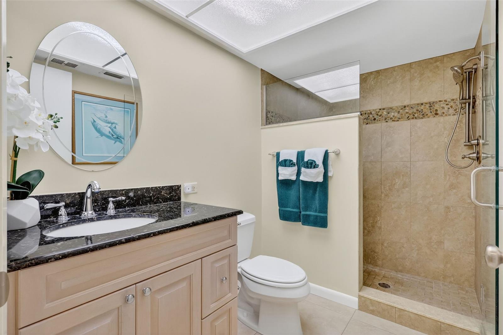 The Guest Bath also has single vanity and large shower with glass enclosure