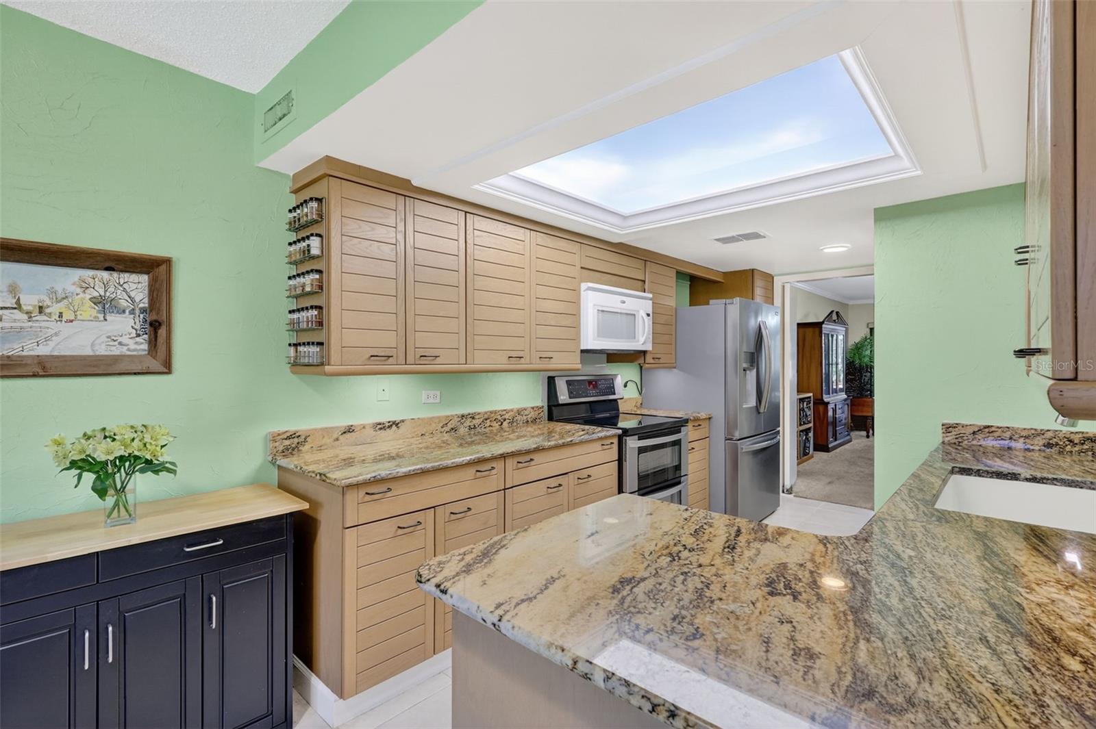 This kitchen is ready for you and your guests with plenty of work space and storage, stainless steel appliances, and and granite counters