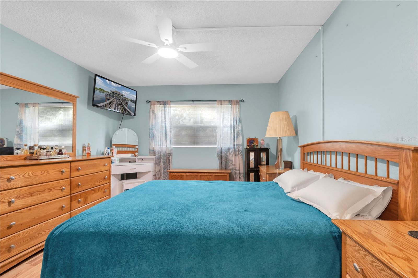 Primary Bedroom with ceiling fan, natural light, and walk in closet