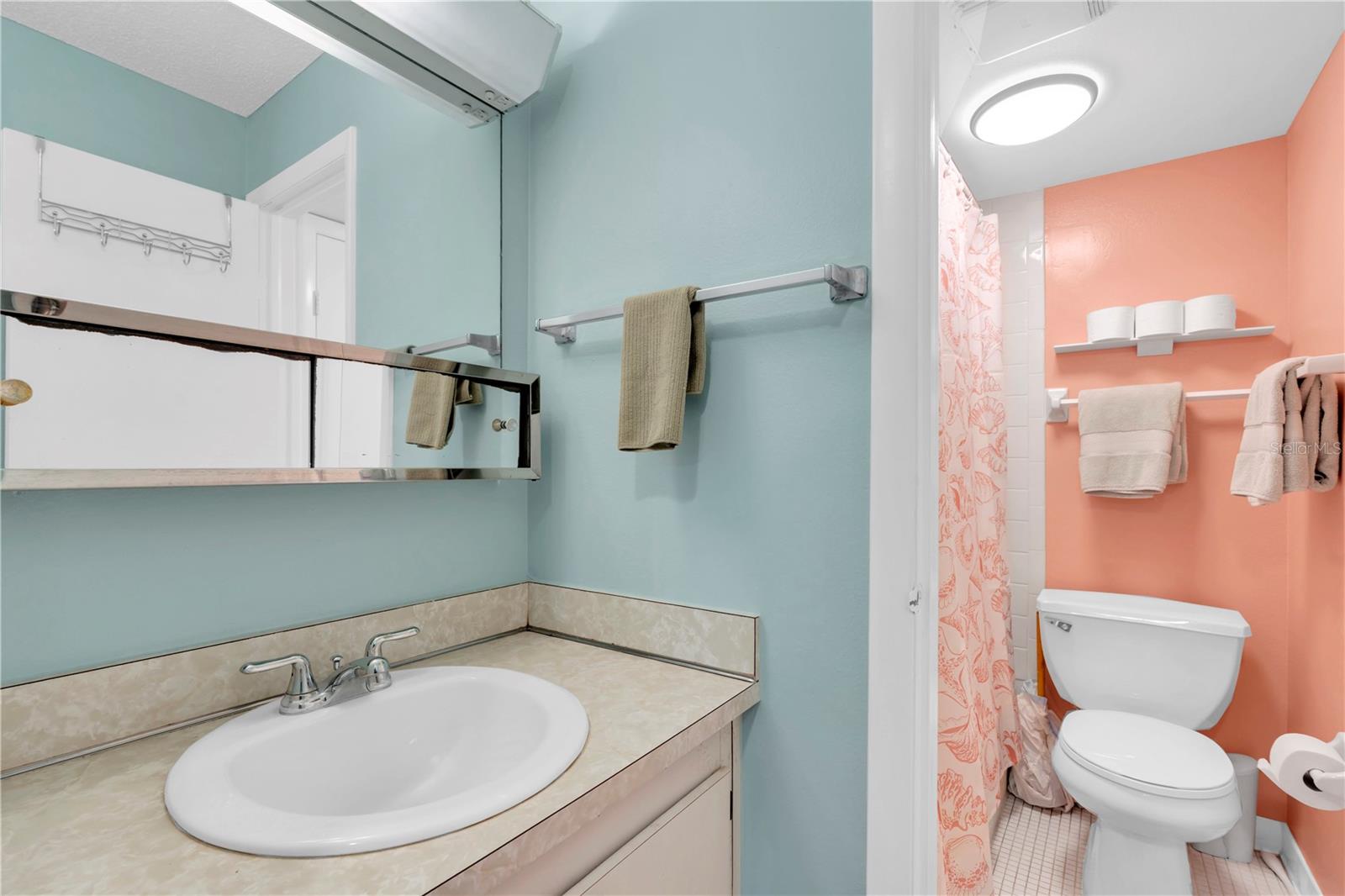 Primary Bathroom with vanity area and tub/shower combo