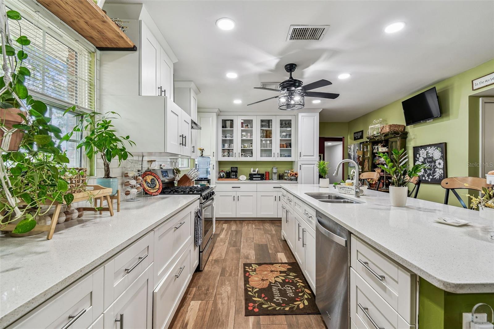 Kitchen redone a few years ago with Quartz countertop, soft-close cabinets and drawers, Pot drawers, Spice racks, ample storage with large pantry to the right.