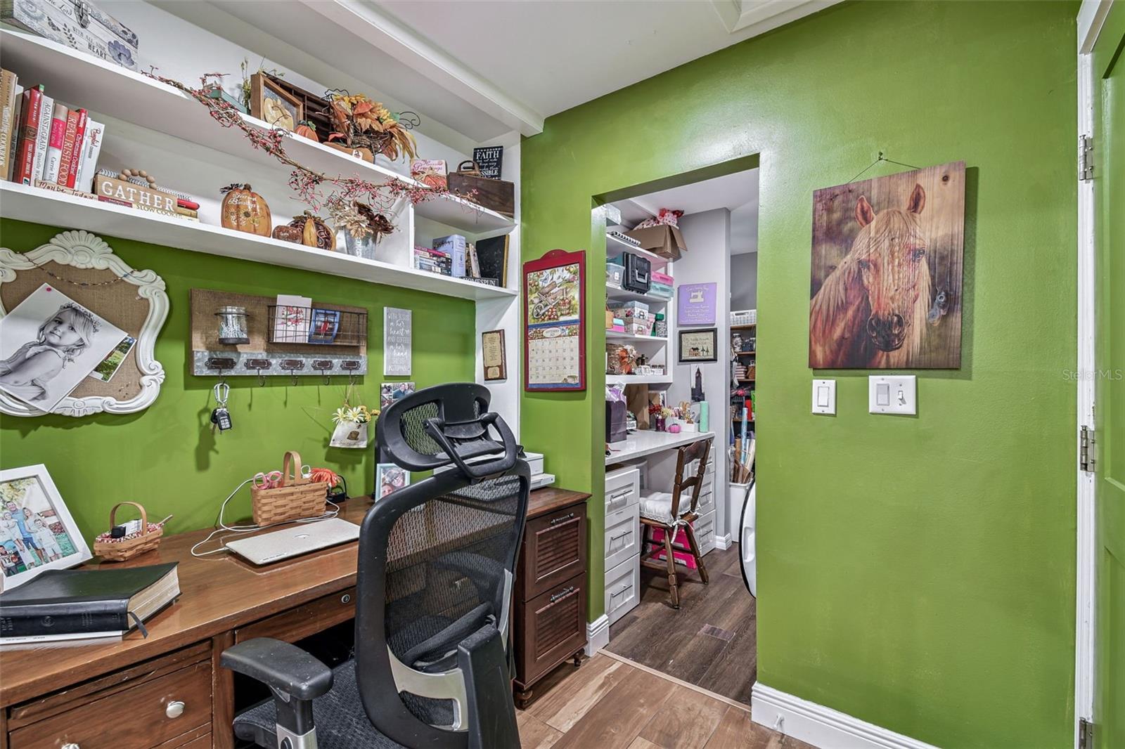 Office Space right off the kitchen area leading to the laundry area and extra storage