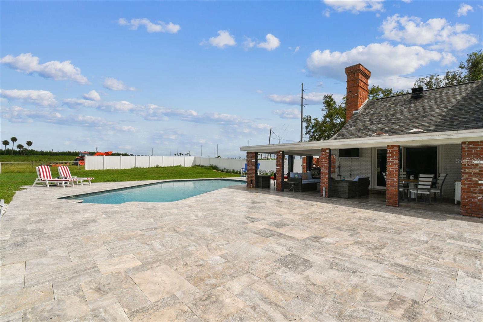 Expansive travertine tile lanai