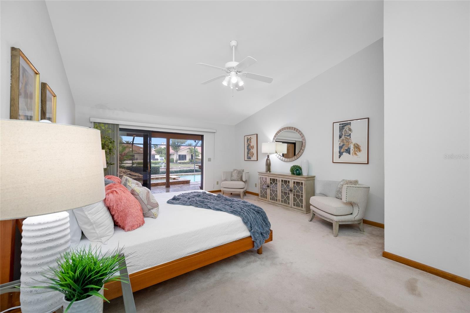 Primary Bedroom suite with triple sliders and private access to lanai and pool