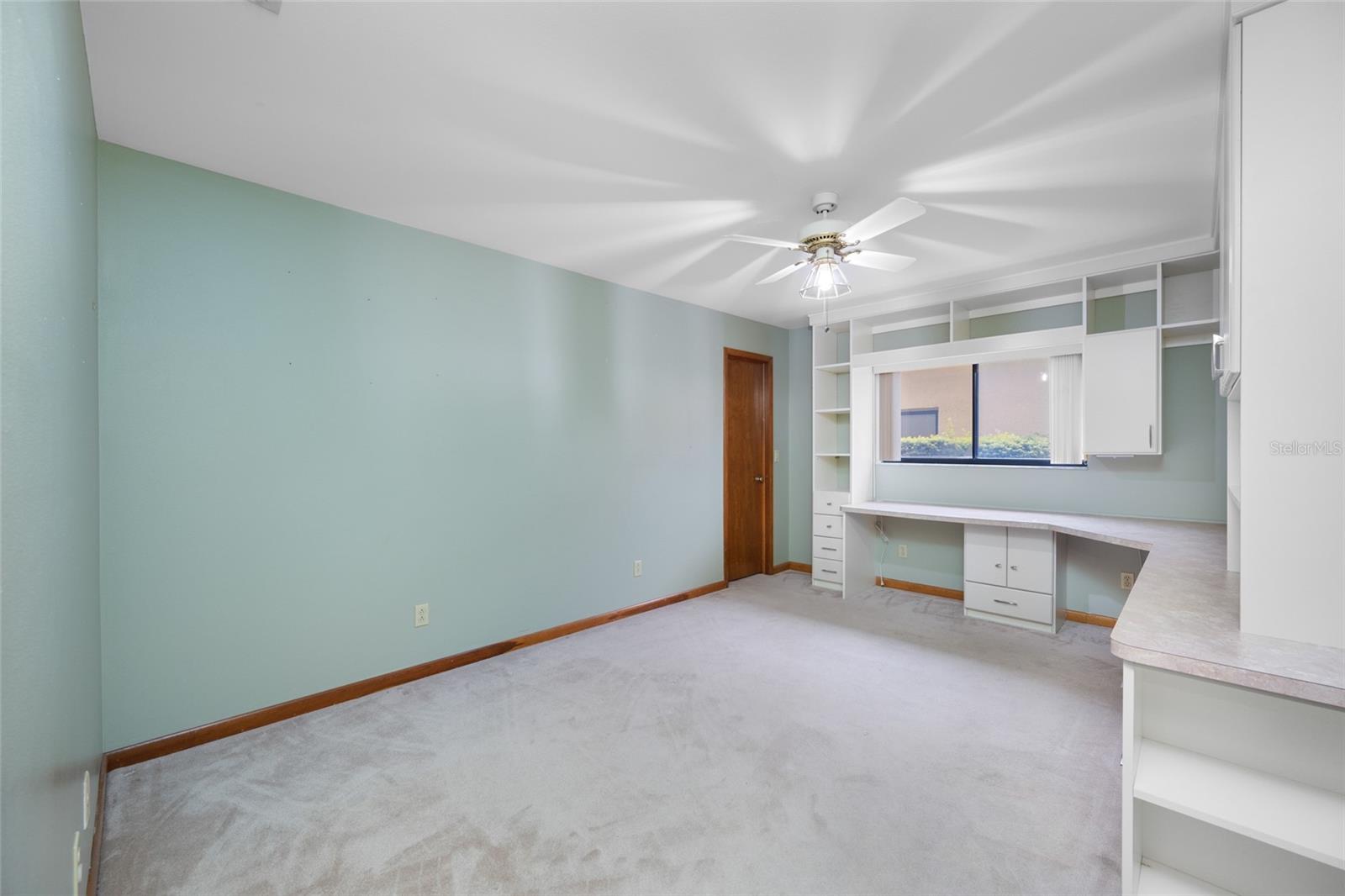 4th bedroom with walk in closet and custom built ins