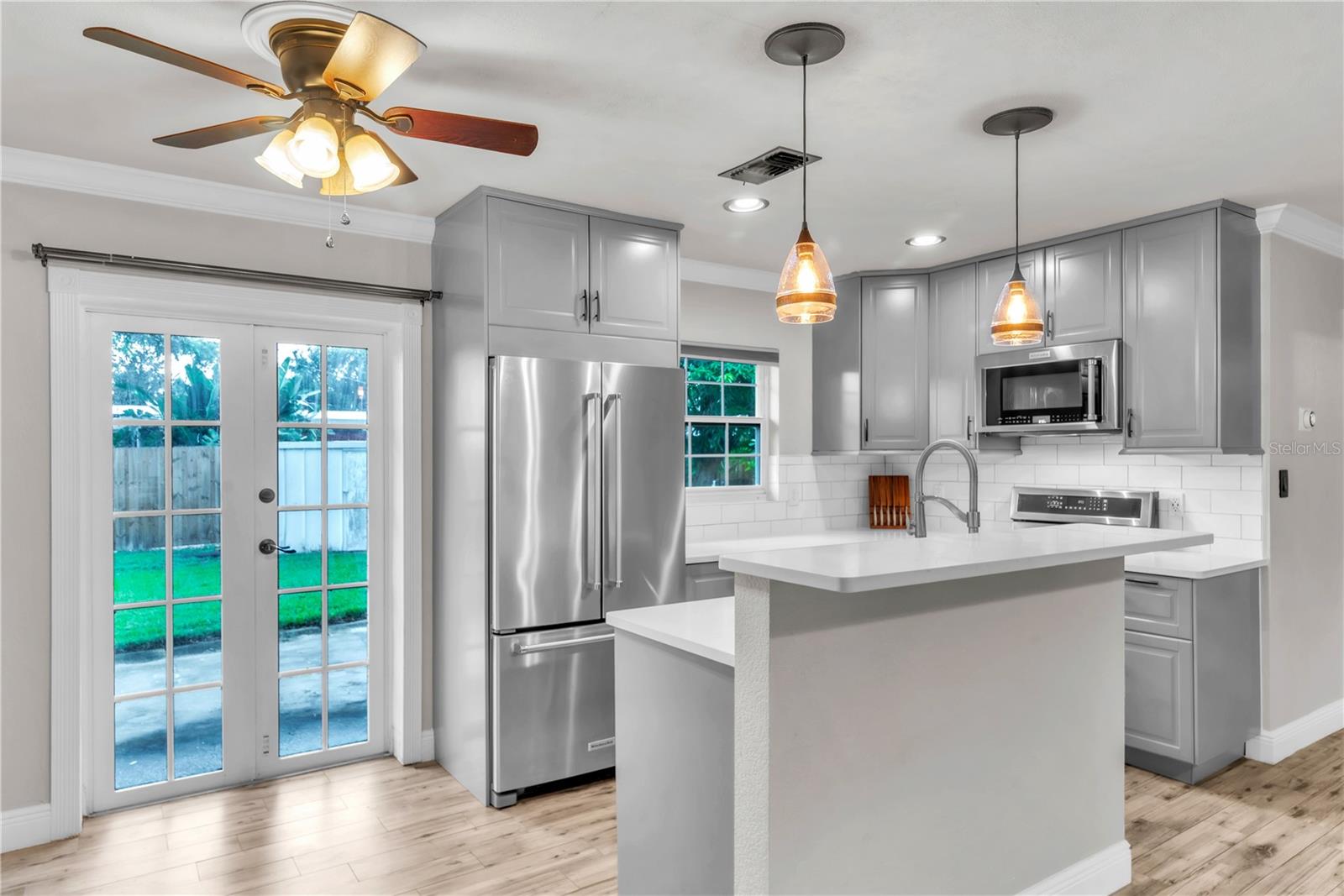 French doors lead to the expansive backyard