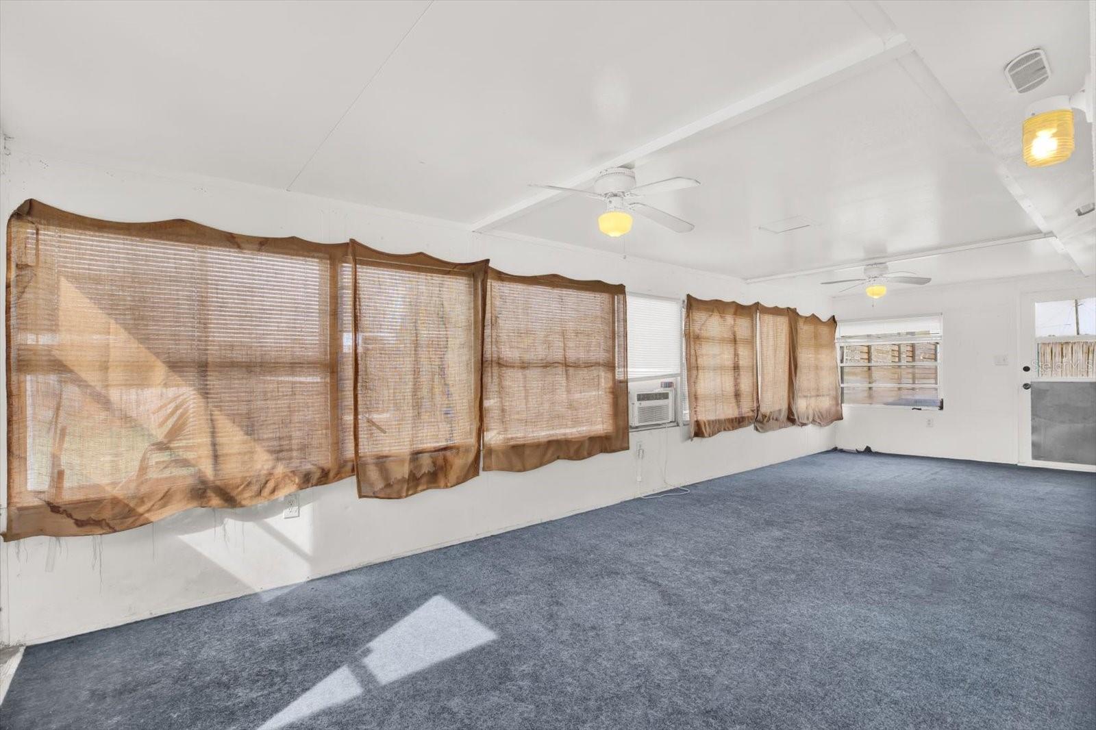 Florida room is perfect to sit in while enjoying the yard and entertaining guests