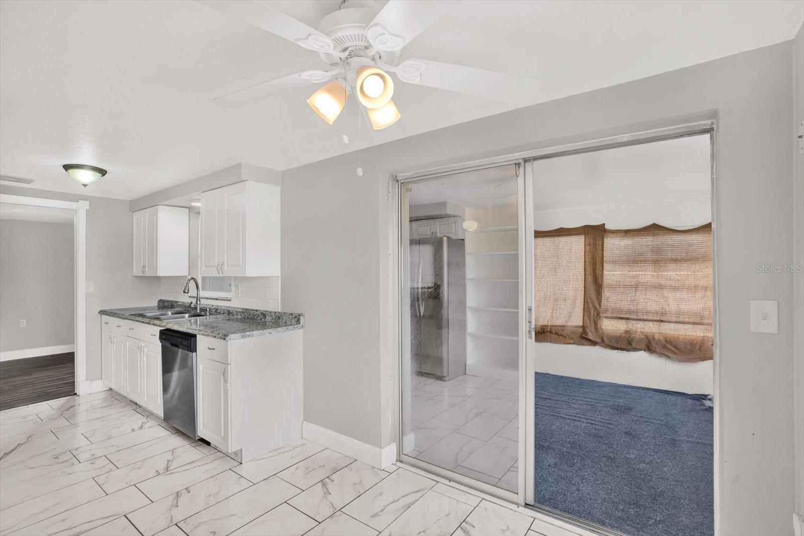 kitchen is accessible to screened florida room with separate AC unit